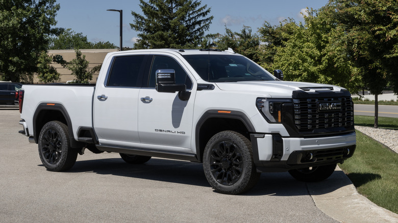 A white GMC Sierra 2500 4WD Denali Ultimate on display on a sunny day.