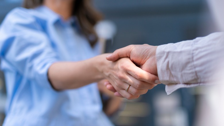 close up of unidentified man and woman shaking hands