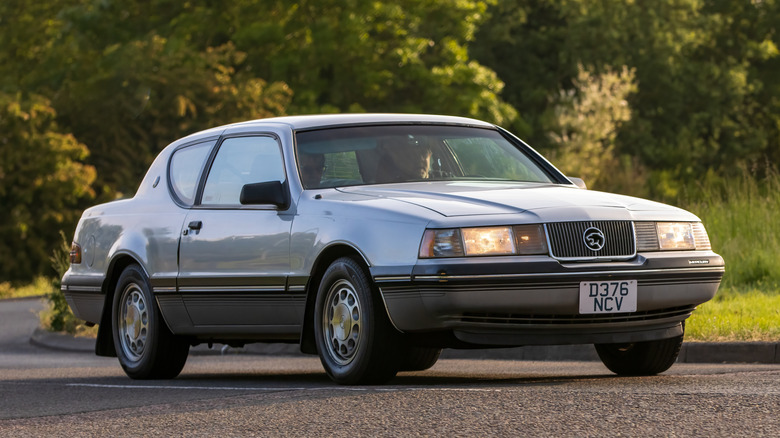 Ford Mercury Cougar classic car travelling on a country road.