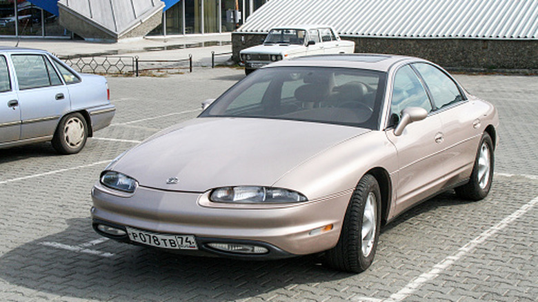 Oldsmobile Aurora in the city street.