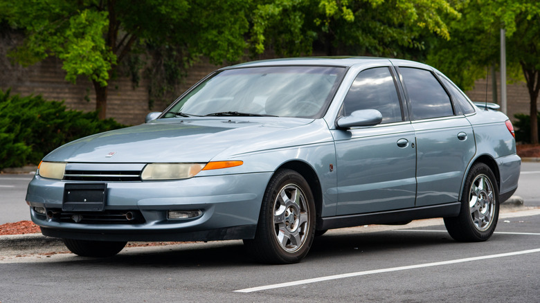 A gray Saturn L-Series L300 parked on the street.