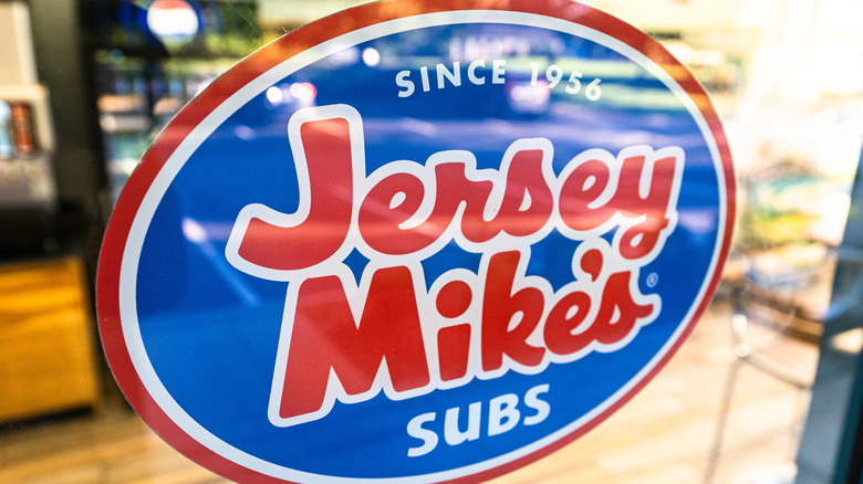 Close up of Jersey Mike's restaurant door with logo on front