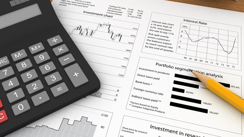 calculator, pencil, and retirement investment documents