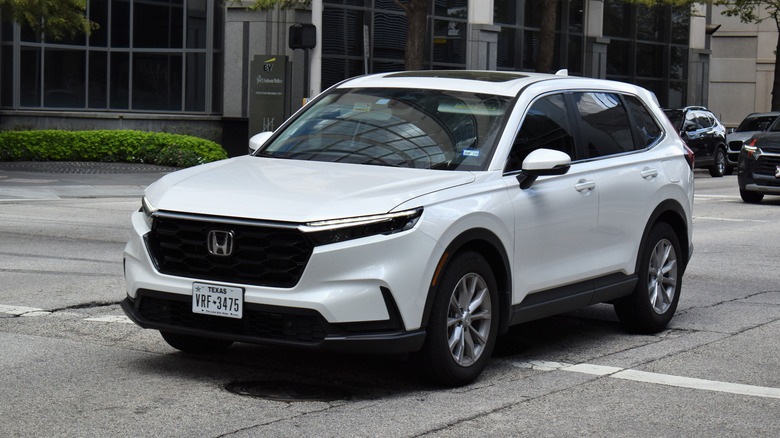 A Honda CR-V SUV, cruising in the downtown financial district of the city.