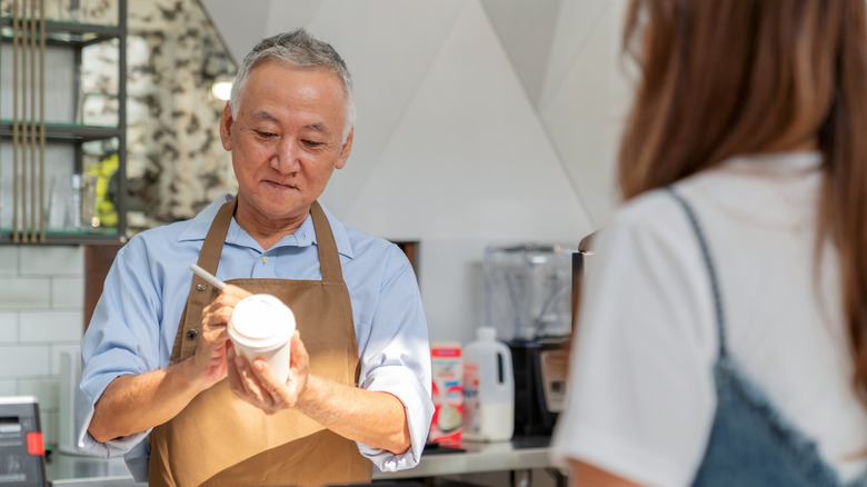 older man working in coffee shop