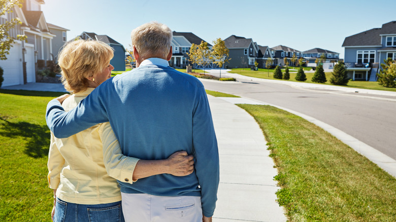 retired couple walking in a suburban neighborhood