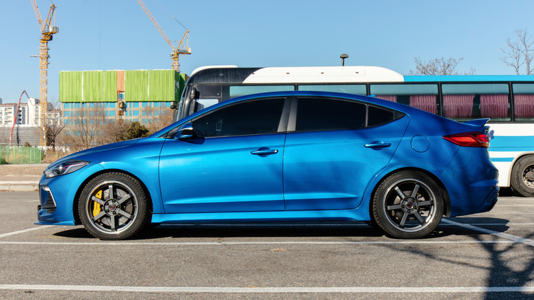 A blue Hyundai Elantra Sport sedan parked in a parking lot with a construction site in the background.