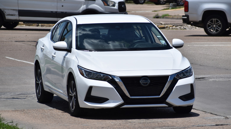 A white Nissan Sentra cruising near William Hobby Airport