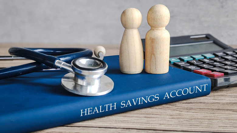 people figurines on a health savings account notebook