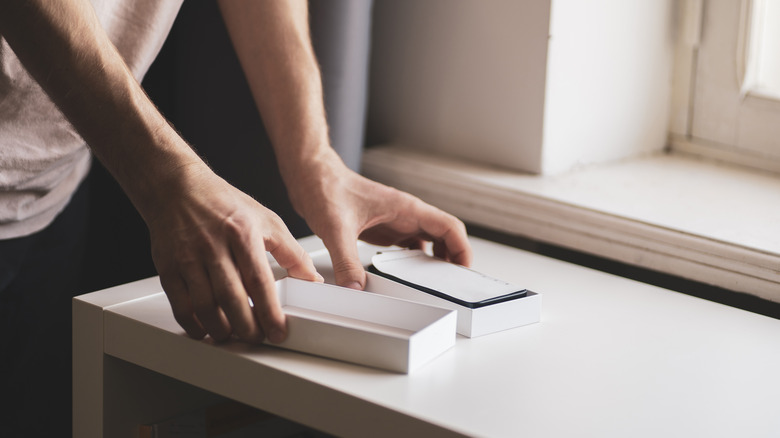 person unboxing a new phone