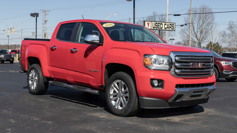 Used red GMC Canyon on display at a dealership.