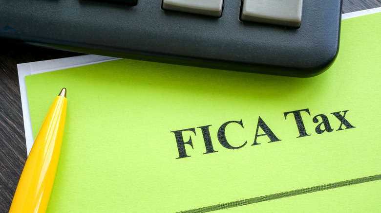 "FICA Tax" printed on a piece of paper next to calculator
