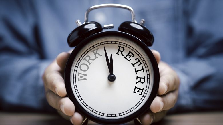"work" and "retire" written on a clock face