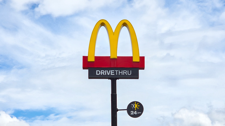 McDonald's sign outside of restaurant against blue sky