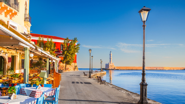 Colorful waterfront stores and outdoor tables and chairs