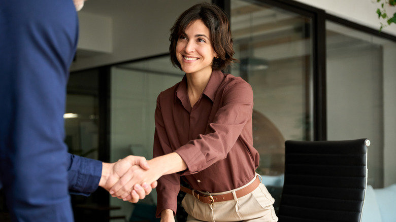 Female HR manager shaking hands with recruit