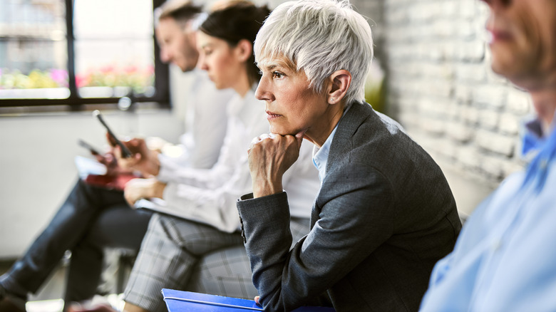 Mature woman looking worried while waiting for interview