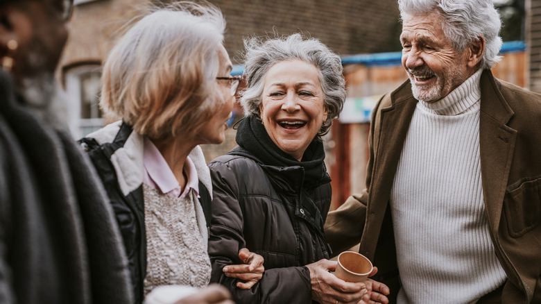 An elderly group of friends laughing together.