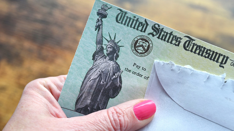 opening a letter containing a Treasury Department check