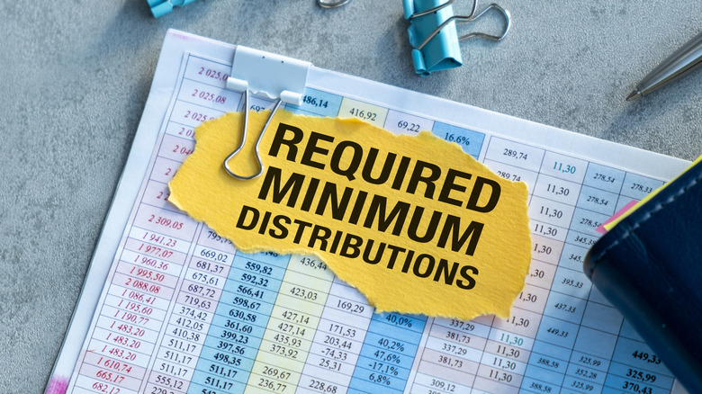 Financial document with a yellow paper on top reading "required minimum distributions"