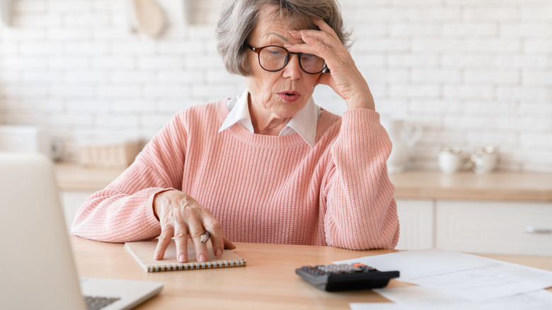 senior sitting at table worrying about something