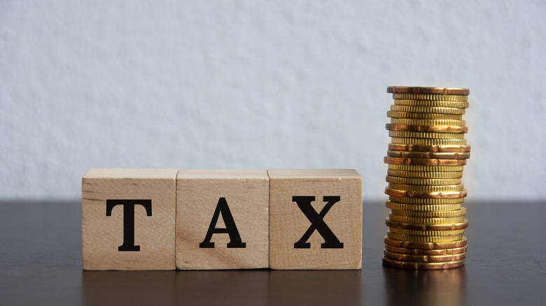 tax spelled in blocks and a stack of coins