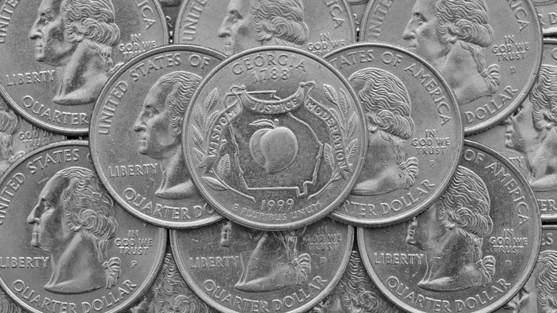 A Georgia state quarter with atop other standard quarters