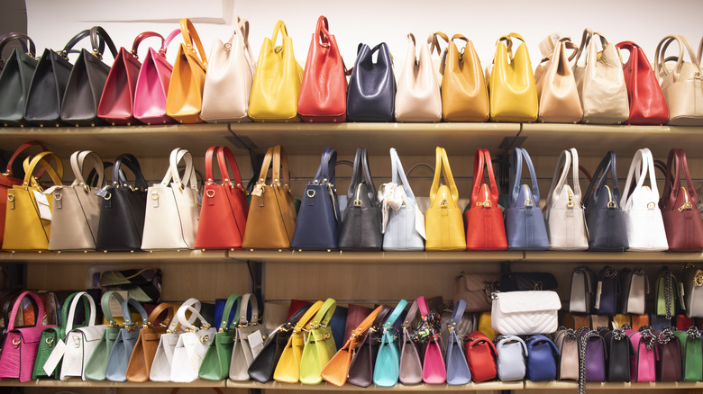 rows of purses lined up in a store