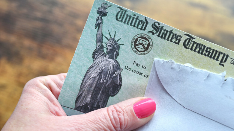 Women holding Social Security check.