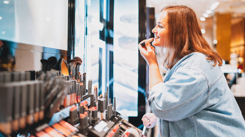 A woman shopping for makeup inside a beauty store