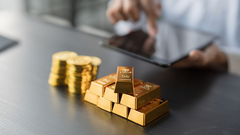 Gold bars and coins on a desk