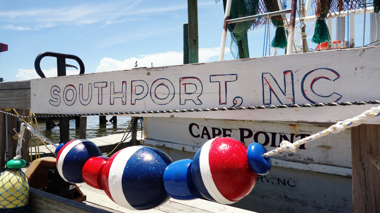 Weathered dock sign reading "Southport, NC"