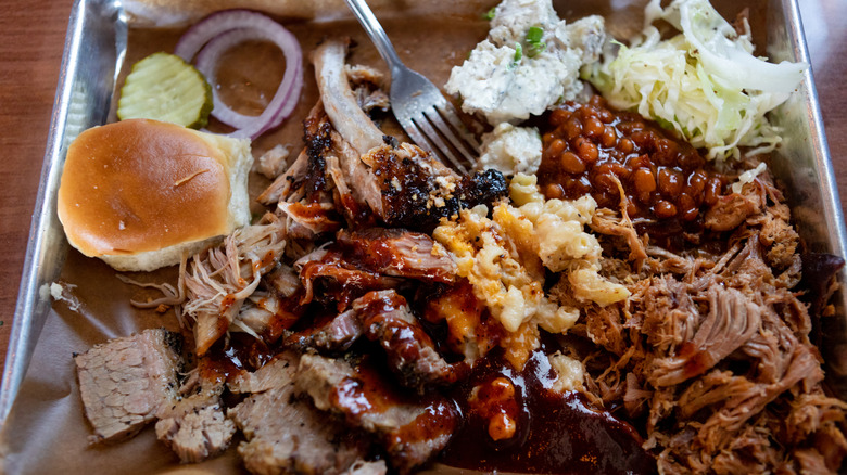 Close-up photo of barbecued meats on metal tray