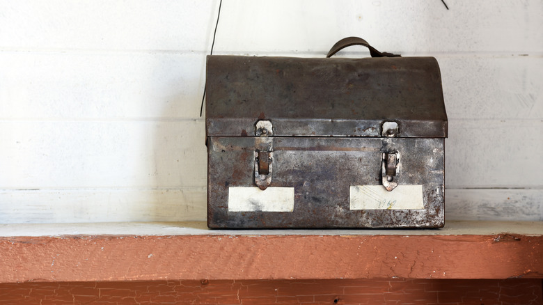Vintage lunch bucket on a shelf