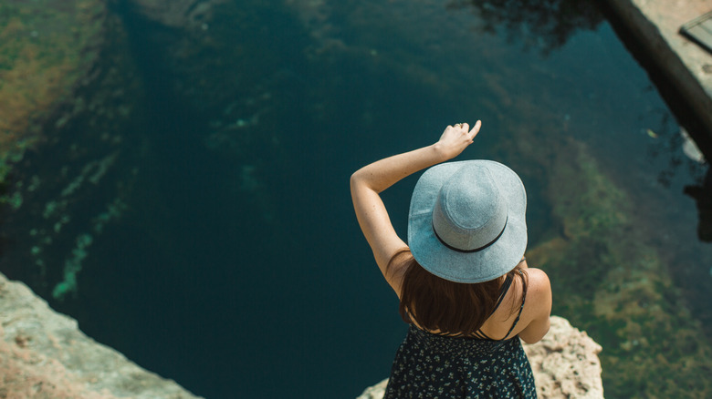 Female tourist at Jacob's Well, Wimberley, Texas.