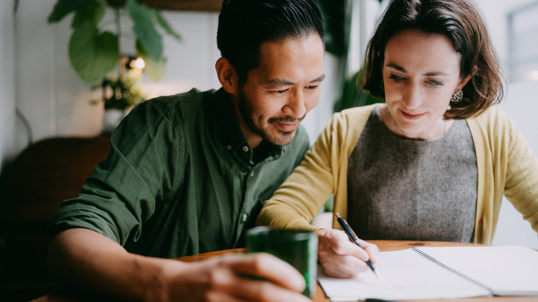 Couple budgeting to save for home.