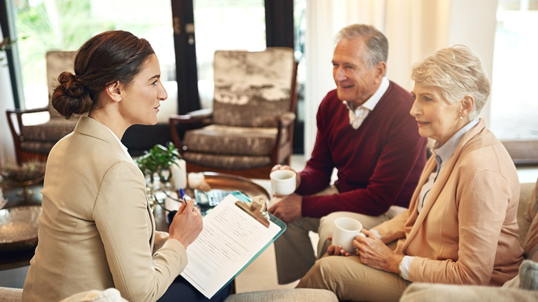Senior couple working with young woman on planning