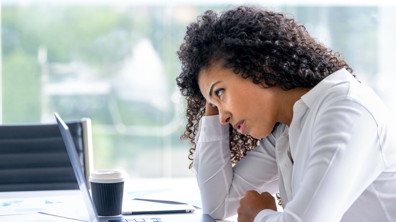 Upset woman staring at a laptop