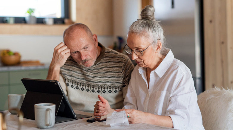 retired couple looking worried about finances
