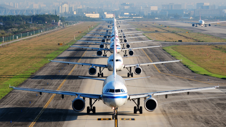Airplanes lined up on tarmac