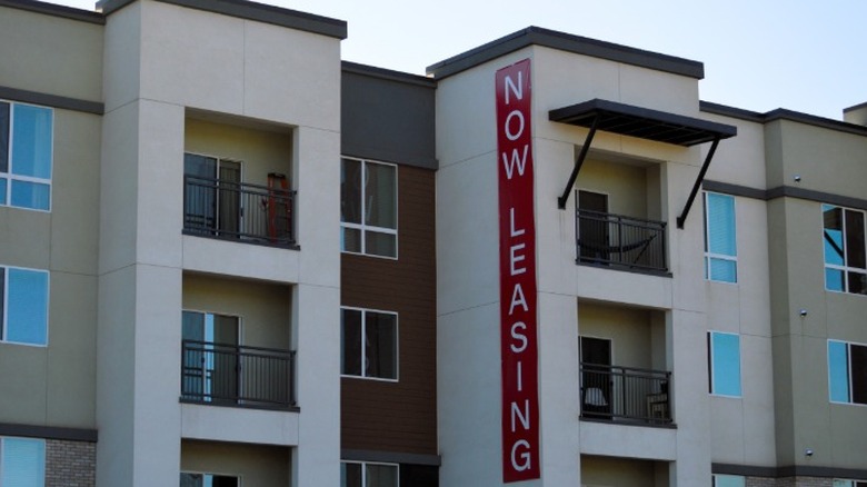 An apartment building in Arizona with a now leasing banner running down an outside wall.