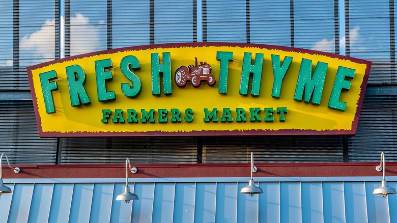 Fresh Thyme Farmers Market grocery store's exterior facade brand and logo signage on a sunny day.