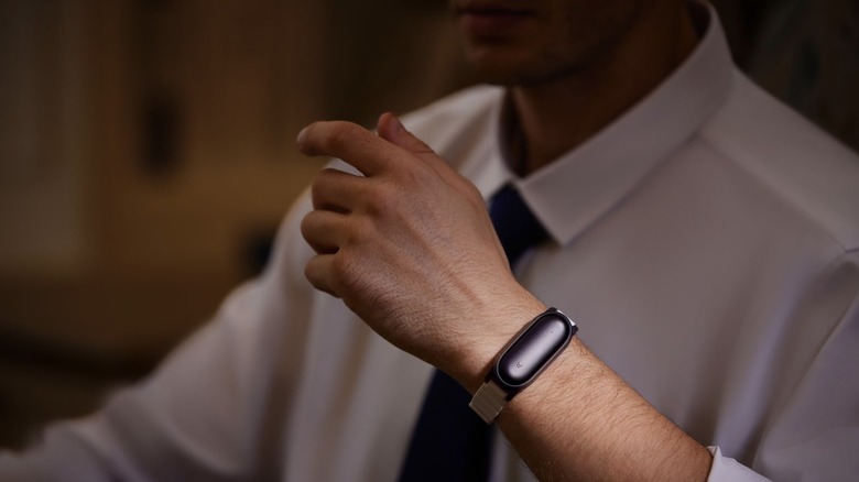 man with plaudai notepin on wrist