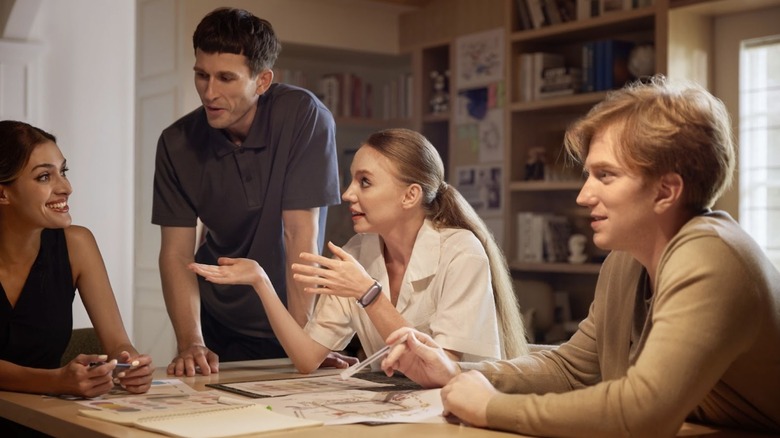 group of people talking at kitchen table