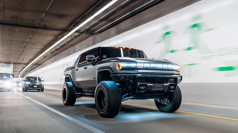 2023 GMC Hummer EV Pickup driving through a tunnel