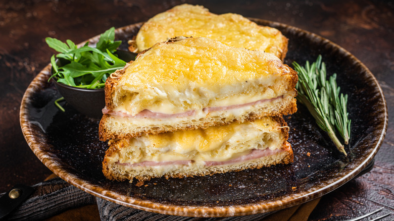 A croque monsieur sandwich on a plate with garnish