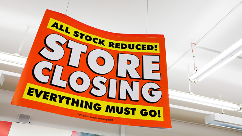 Sign hanging from ceiling reading Store Closing