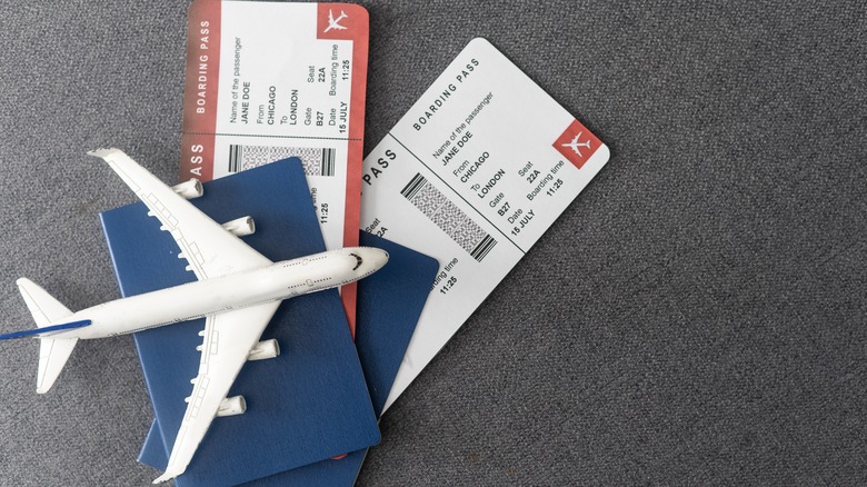 Toy plane on top of boarding passes and passports