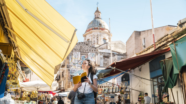 A tourist walking through a European market