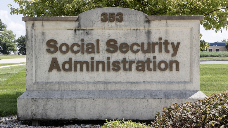 A cement sign outdoors that says "Social Security Administration"